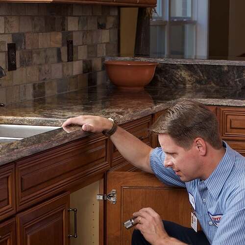 technician checking drain and faucet