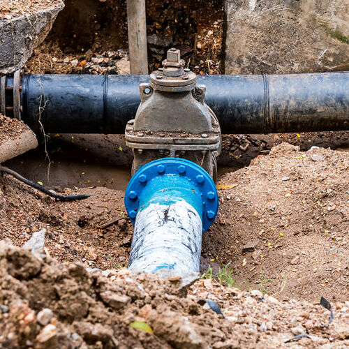 Water PVC Plastic Pipes in Ground during Plumbing Construction site.